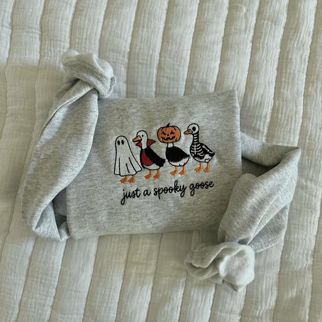 A cozy embroidered sweatshirt featuring adorable Halloween designs you'll love wearing all season.