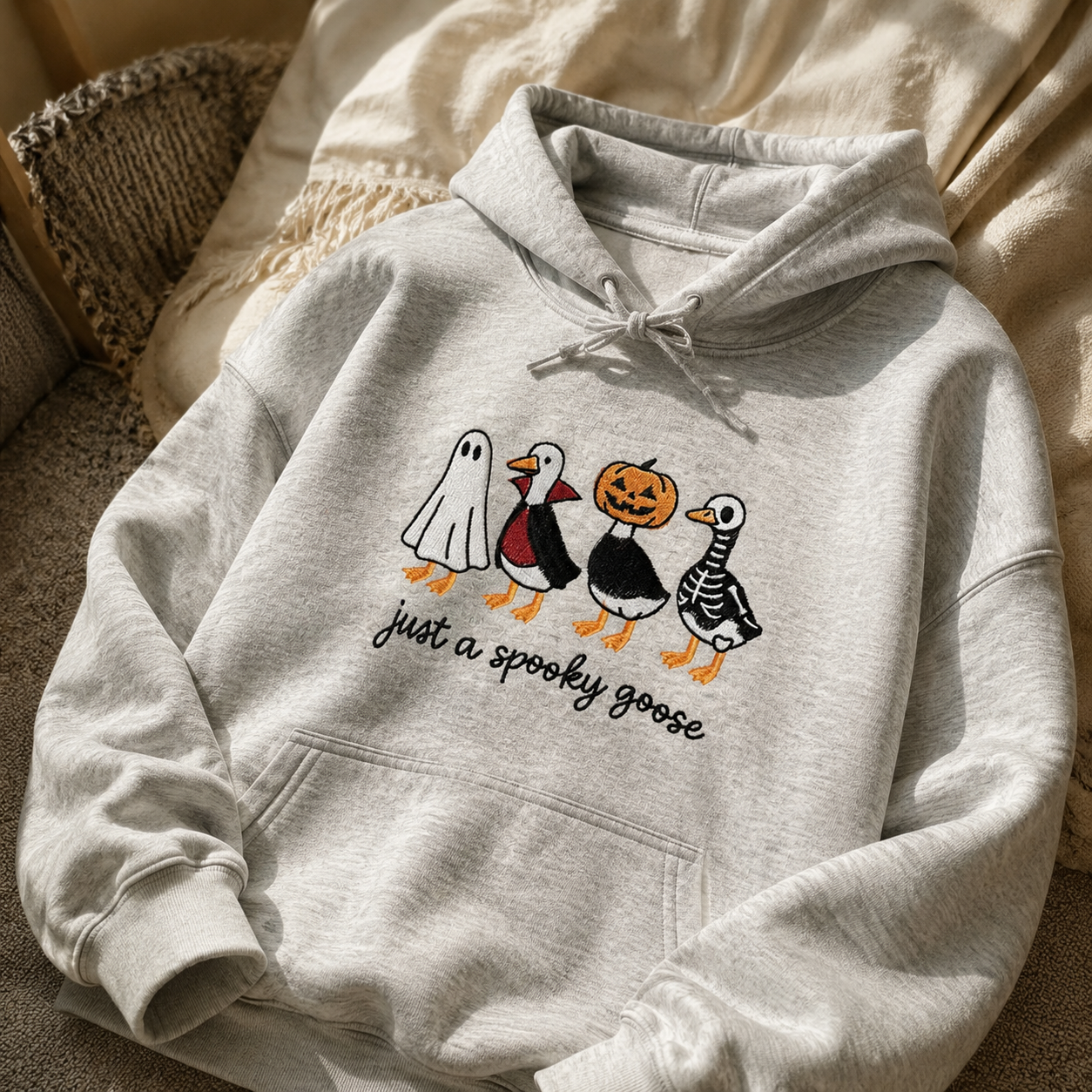 A cozy embroidered sweatshirt featuring adorable Halloween designs you'll love wearing all season.