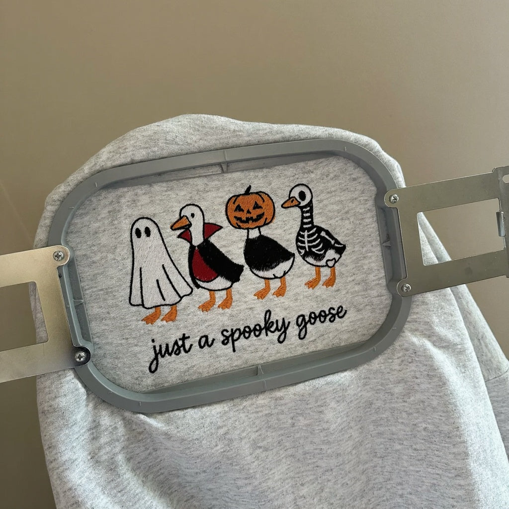 A cozy embroidered sweatshirt featuring adorable Halloween designs you'll love wearing all season.