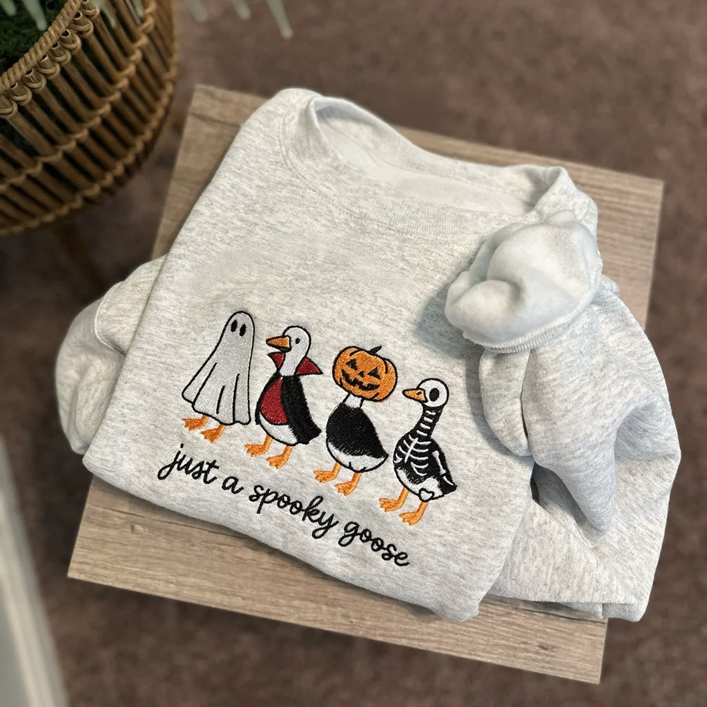 A cozy embroidered sweatshirt featuring adorable Halloween designs you'll love wearing all season.